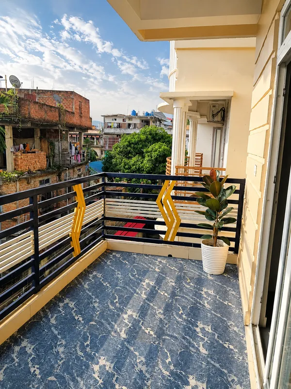 Hollong Suite balcony with railing and potted plant