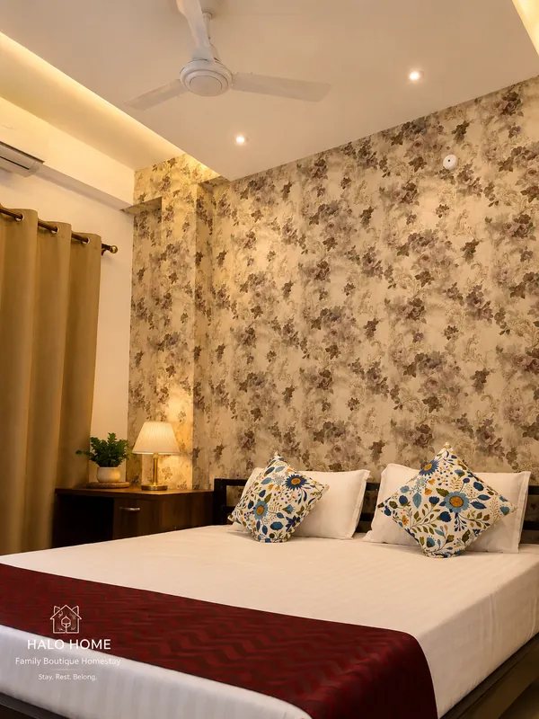 Hollong Suite bedroom with king bed and floral wallpaper