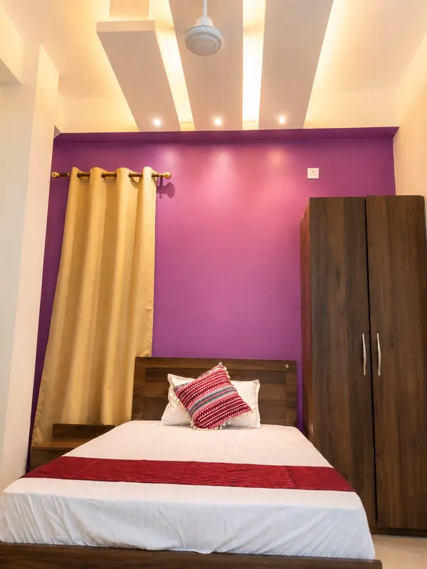 Hollong Suite second bedroom with queen bed and purple wall
