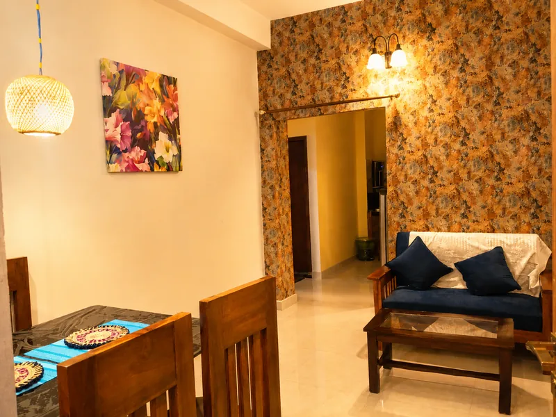 Hollong Suite living room with sofa and dining chairs