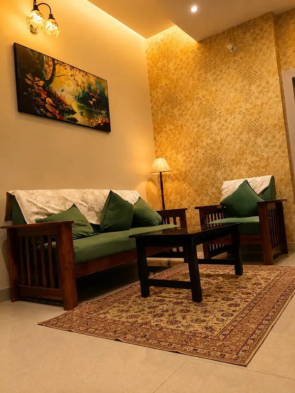 Simolu Suite living room with sofa, rug and painting